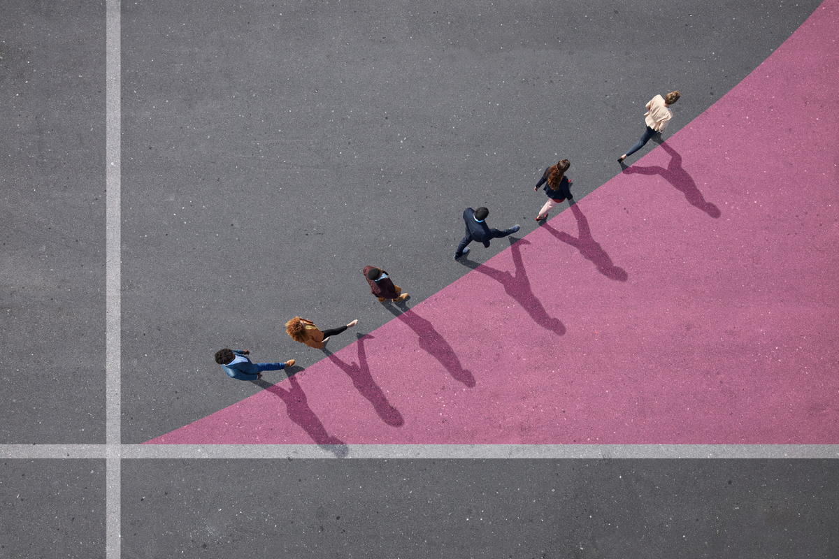 People walking on a blacktop along a graph that is painted on it