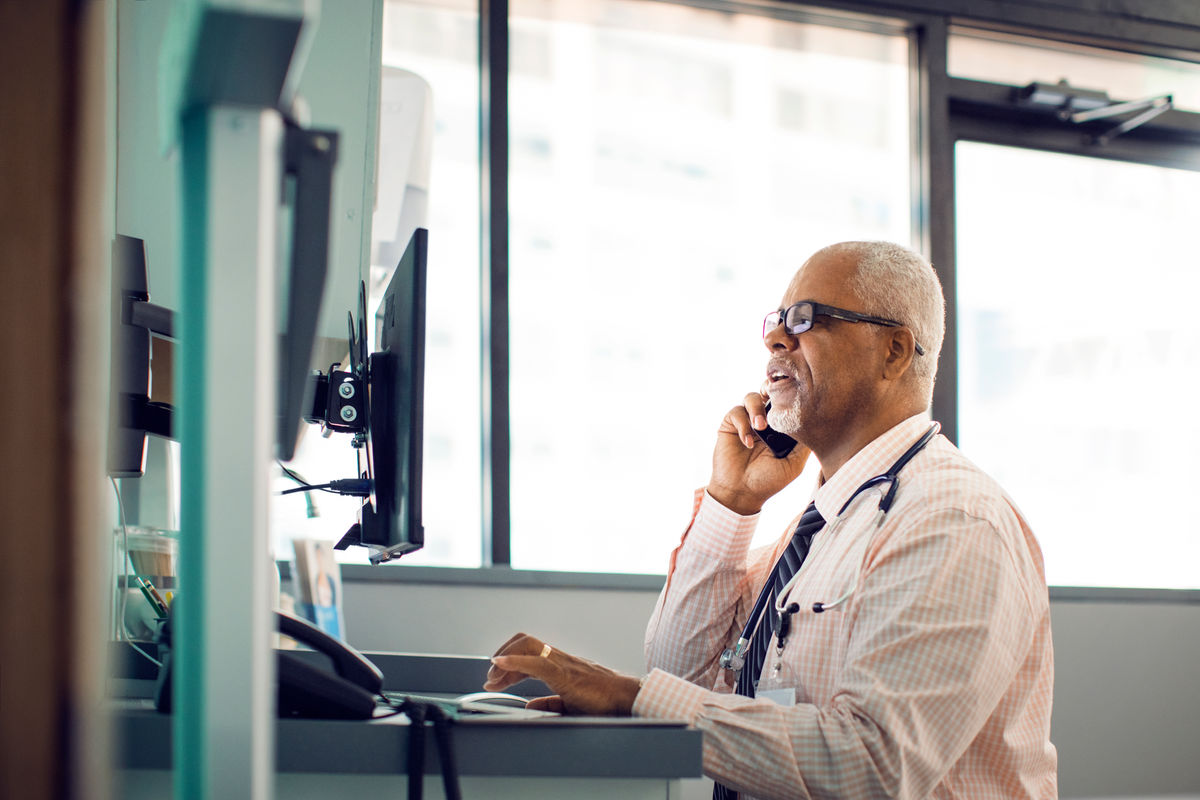 Provider on the phone while looking at a computer screen