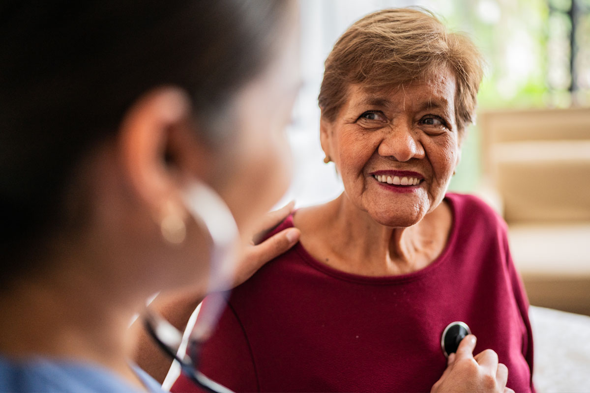 older woman getting her heart checked by a provider
