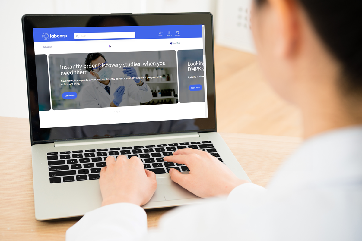 Provider with laptop. The screen is displaying the Discovery Oncology Ordering Portal