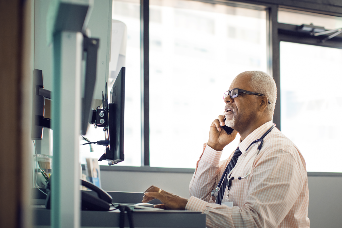 Provider on the phone while looking at a computer screen