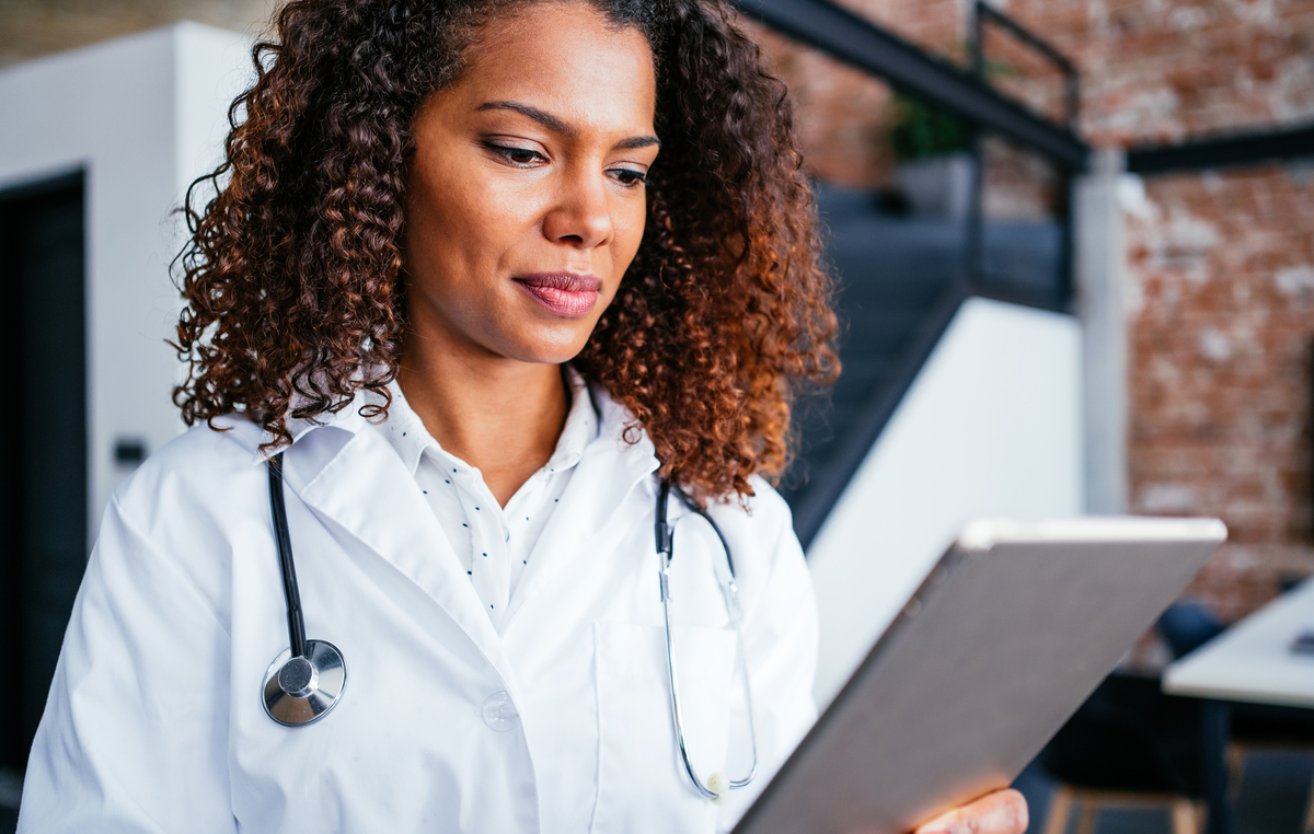 Provider holding a tablet in their office