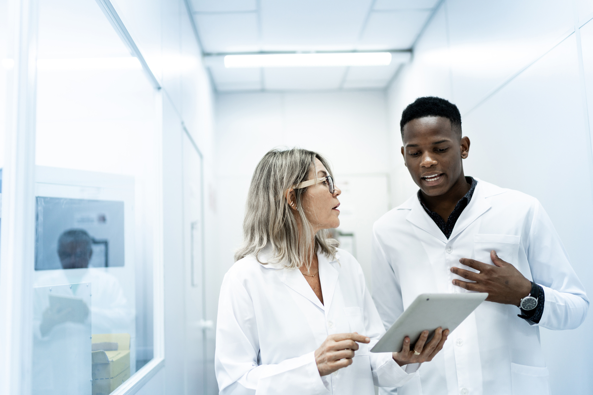Two scientists going over results on a tablet