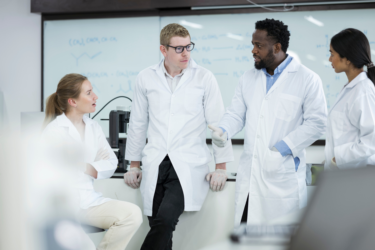 Collaboration and Team Science in Laboratory Research. Diversity of Scientists or Researcher is having a team meeting together in microbiology laboratory