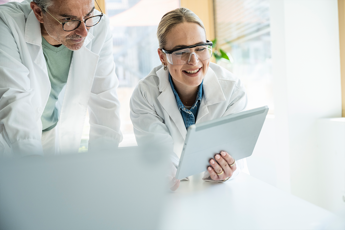 Two scientists looking at results with smiles on their faces